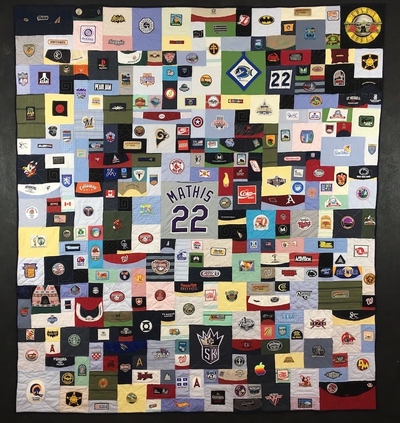 Baseball hats and patches made into a quilt.