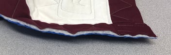 The raw edge of a T-shirt quilt