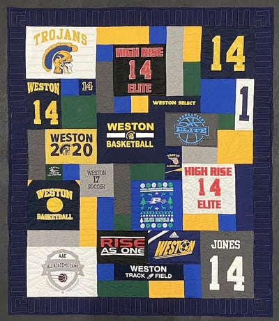 Use a border and blank blocks to make a T-shirt quilt large.