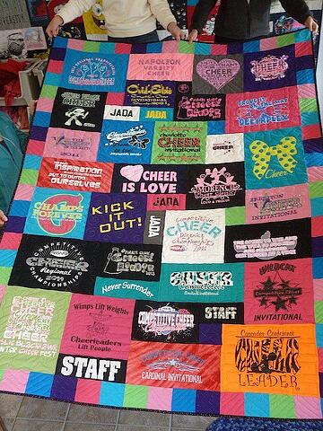 A cheerleading T-shirt quilt with a colorful border by Too Cool T-shirt quilts