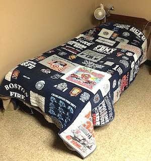 This is a firefighter's T-shirt quilt on the bed at the firehouse. 