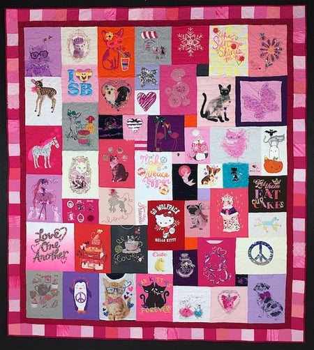 A little girl T-shirt quilt with a pink border