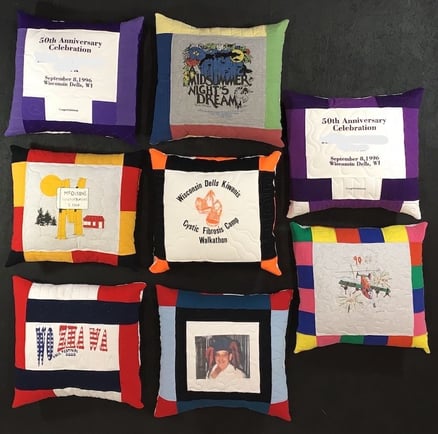 A group of 8 memorial pillows made from T-shirts.