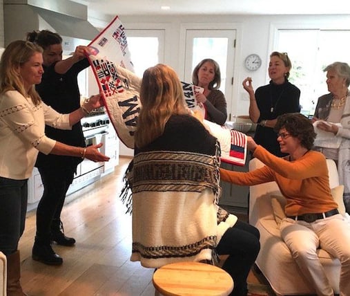 women opening quilt