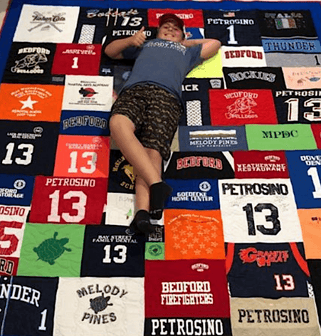 boy on quilt happy