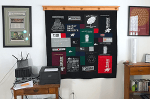 A T-shirt quilt hanging in an office